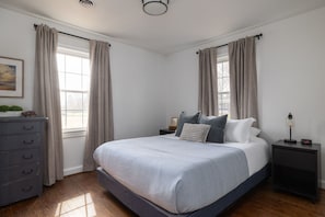 Secondary bedroom with comfortable queen, dresser, and closet