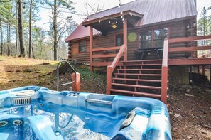 Hot tub is off the back of the cabin.