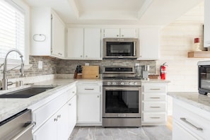 Fully furnished kitchen. Ready to make your culinary and hosting dreams come true! Includes pots, pans, a variety of spices and condiments, Ninja blender, baking sheets, cooking utensils, cooking knives, an Instant Pot, and more!