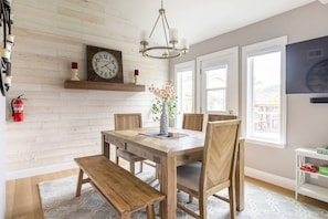 Dining area comfortably seats 6. Bench can be replaced with chairs located in the bedrooms upstairs. Smart tv on a pivot can be viewed from the living area and dining area.