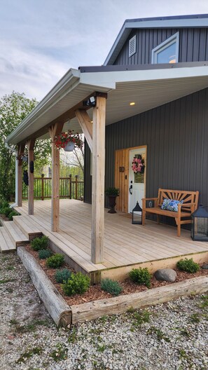 Lush garden beds and a styled entryway.