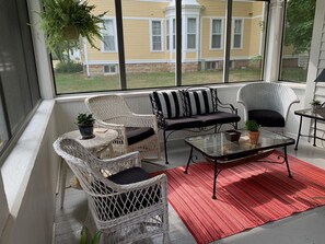 Screened-in porch with wicker furniture