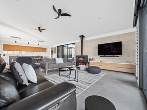 The living area is modern but cosy, offering a fireplace perfect for winter evenings.
