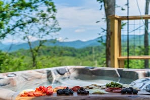 Enjoy a soak in the hot tub with mountain views!