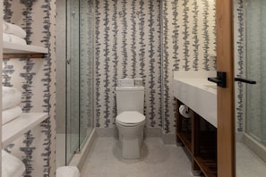 Bathroom with a stylish walk-in shower, providing a touch of luxury and relaxation.