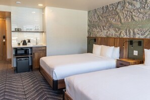Spacious and bright bedroom featuring a comfortable queen bed and modern amenities.