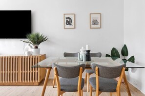A four-seater dining table offers a relaxed space to share meals when you’re not dining out.
