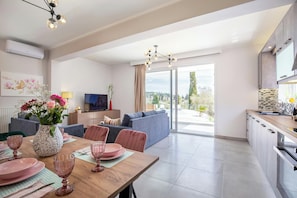 "Relax and unwind in style with a stunning view of the pool from your modern and fully-equipped kitchen. Your dream vacation starts here at our luxurious suites."