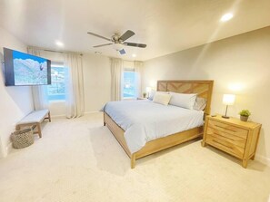 The master suite offers a king size bed, 55" smart TV,  and an en-suite bathroom with walk in shower with two shower heads.