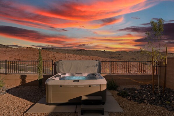 The private, 8 person, hot tub in our fully fenced backyard.