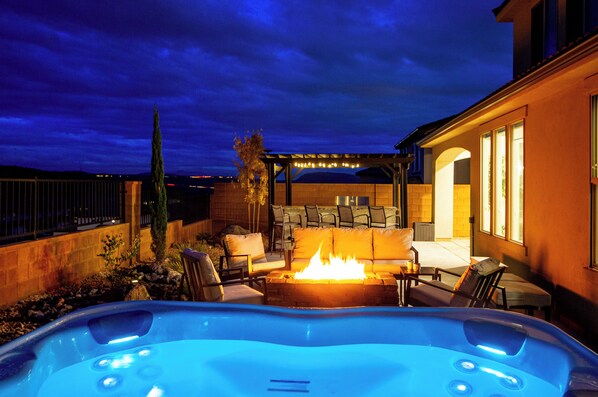 Spacious fenced in backyard, newly remodeled with a hot tub, fire pit, outdoor kitchen and dining.
