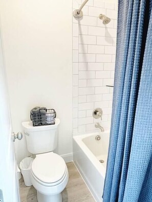 Private bathroom with tub/shower combo and toilet. There is no bathroom sink. There is one sink in the kitchenette. Linens are provided.