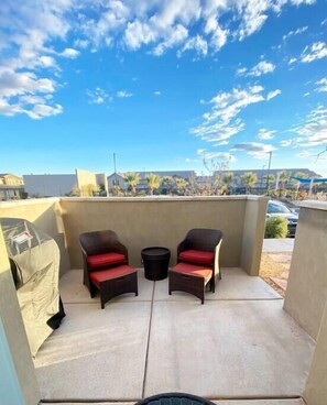The private patio offers seating for two and a gas grill. 