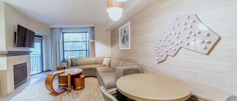 Large living room with sectional couch, TV, and dining area.