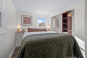 Bedroom #1 features a quality queen mattress, side tables with USB ports, a large closet area and a dresser. Each bed is draped in fresh, clean, high-quality linens to ensure a good night's sleep.