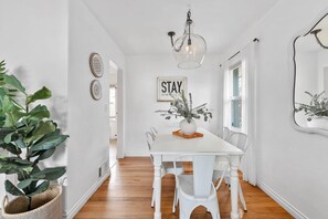 The dining area includes a table that can seat up to 4 guests.