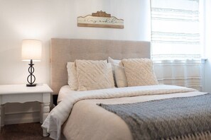 Soft, comfortable bedding adorns each bed in the home for a perfect night's sleep. This room, the downstairs queen bed room connects with the bunk room.