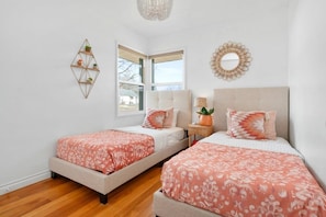 The second bedroom includes two twin-size beds with soft, high-quality sheets.