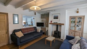 Living room with cosy stove and views out to sea or to the street