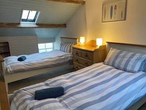 2nd floor twin bedroom with Captain's window and view out to sea