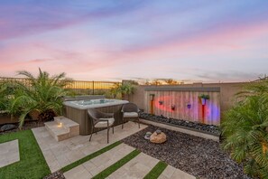 Indulge in the epitome of relaxation with exclusive access to a hot tub nestled beside a mesmerizing, colorful waterfall. 