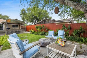 Backyard area with cozy seating to relax, beautiful landscaping and outdoor bar area