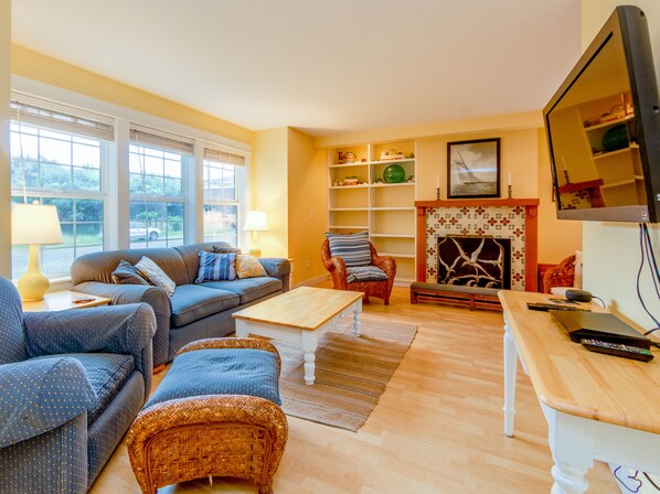 Living room with gas fireplace, streaming TV, DVD player.