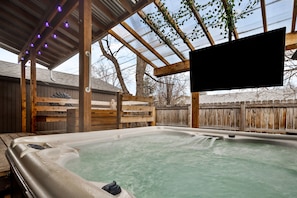 Hot tub and TV in backyard