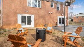 Backyard with adirondack chairs and fire pit