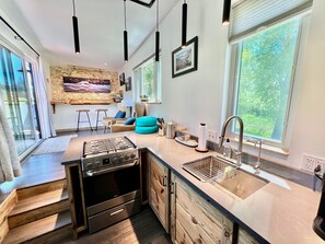 Well sized kitchen includes full fridge, freezer, oven, and 4 burner gas stove