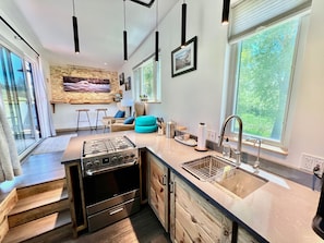 Well sized kitchen includes full fridge, freezer, oven, and 4 burner gas stove