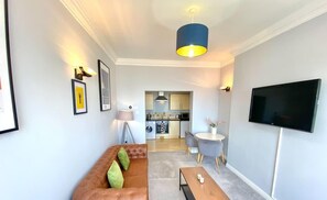 Comfortable sofa with window armchair and large smart TV with netflix