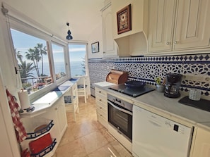 Sea views kitchen with accesses window to balcony