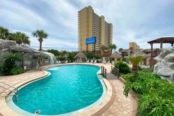 Enjoy the pool with the peaceful sounds of the waterfall and lush greenery.