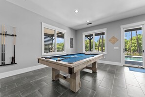 Pool table in lower level living area with partial kitchen and wet bar! 