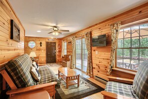 Living room with TV, futon, & sliding glass doors to Large Deck