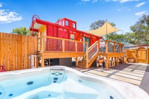 Private hot tub enclosed with privacy fence.