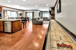 The shuffleboard table in the living area will keep the family playing games all night