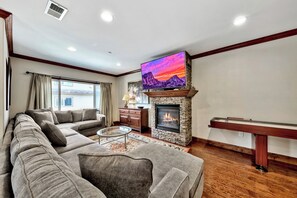 Enjoy movie night on the 55in TV above the gas fireplace with plenty of seating on the large couch