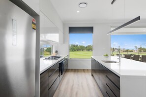 The gourmet kitchen is designed around a breakfast bar with plenty of space to prepare meals or take things slow over your morning coffee.
