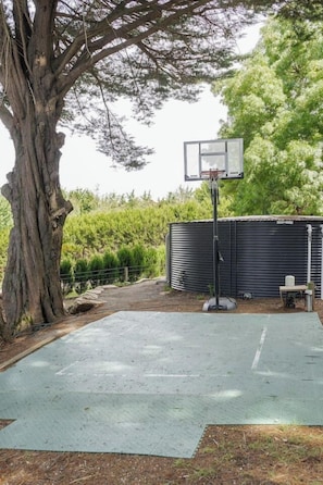 Gather for a friendly game on the backyard basketball court.