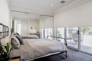 The second queen-sized bedroom opens to the outdoors and boasts beautiful natural light.
