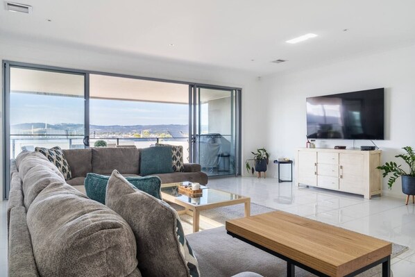 A TV in the living area caters to your evening entertainment, while large sliding doors extend to the undercover patio.