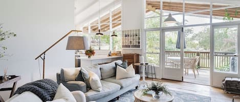 The living room provides comfort in any season. Light a fire in the wintertime, or enjoy a ceiling fan and sliding doors that invite the countryside breeze in on warmer days.