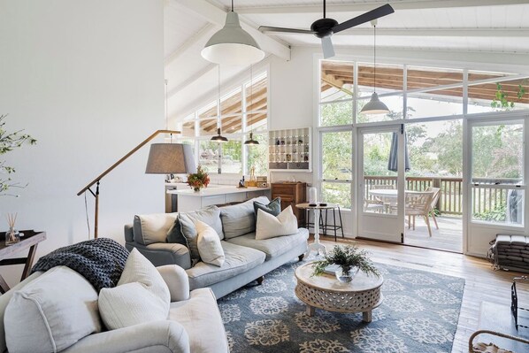 The living room provides comfort in any season. Light a fire in the wintertime, or enjoy a ceiling fan and sliding doors that invite the countryside breeze in on warmer days. 