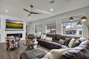 Spacious and bright living room with cozy seating for all.