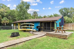 Boat house with attached game room. Includes 6 kayaks, fire pit and picnic table