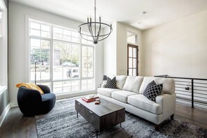 Bright open concept living room with large flat screen TV