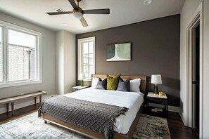 Primary Bedroom with King Bed, large flat screen TV, walk-in closet and en-suite bathroom