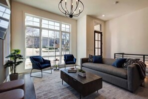 Bright open concept living room with large flat screen TV